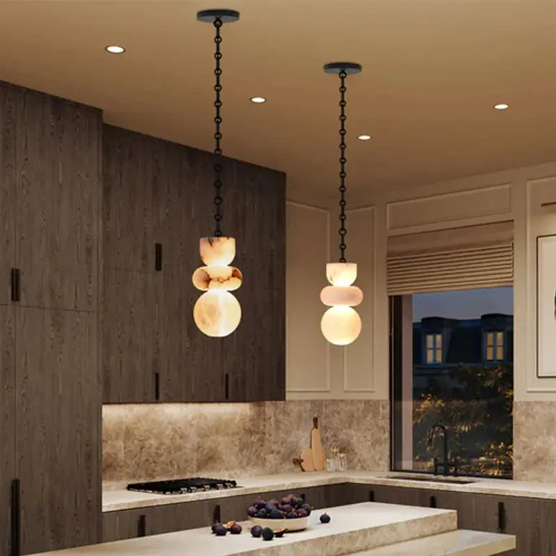 Modern kitchen with pendant lights hanging above a countertop.