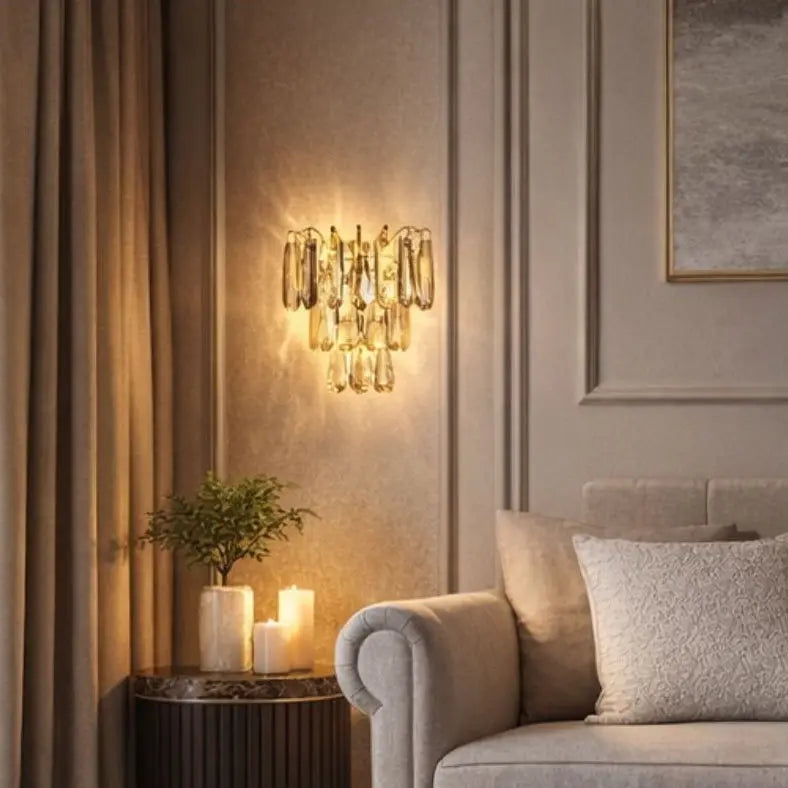 Luxurious living room with a decorative wall light fixture, candles, and a sofa.