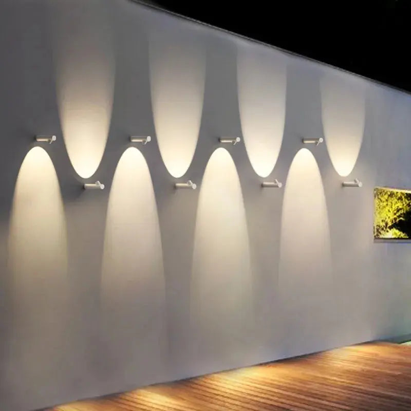 Modern wall lights on a textured wall with a wooden floor.