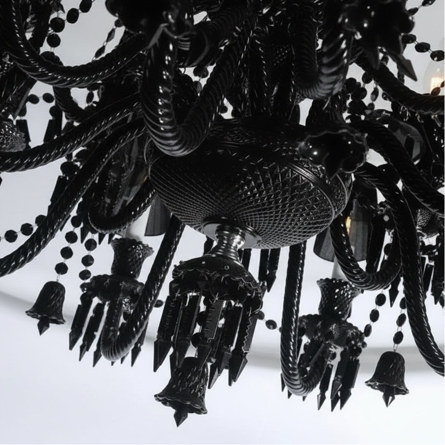 Close-up of a black chandelier with intricate design on a white background