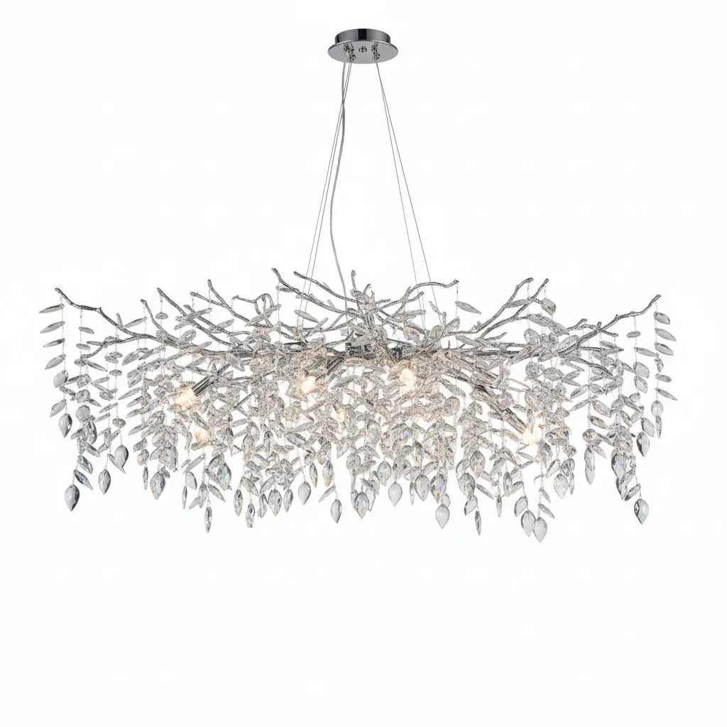 Modern chandelier hanging above a dining table with decor items.