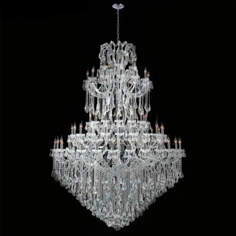 Large crystal chandelier with intricate design on a black background,