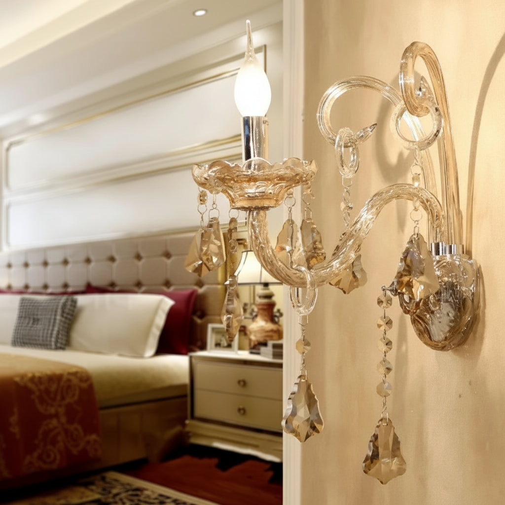 Decorative wall sconce in a bedroom setting with a bed and mirror.