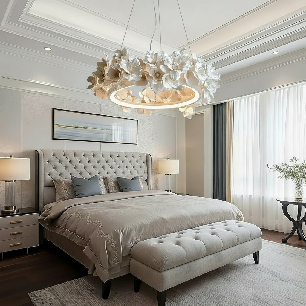 Modern bedroom with a decorative ceiling light fixture, bed, and side tables.
