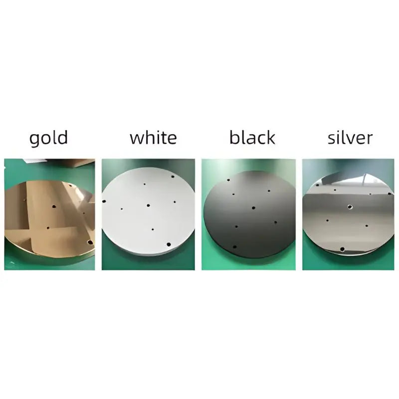 Four circular metal objects in gold, white, black, and silver on a green background.