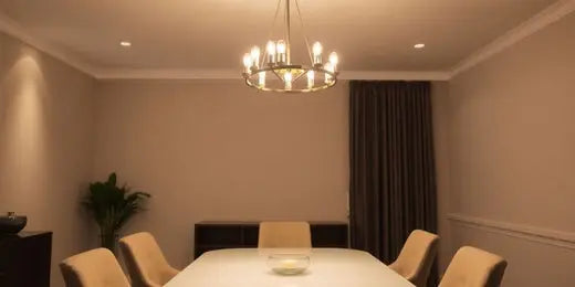 Modern chandelier over a stylish dining table in a room.