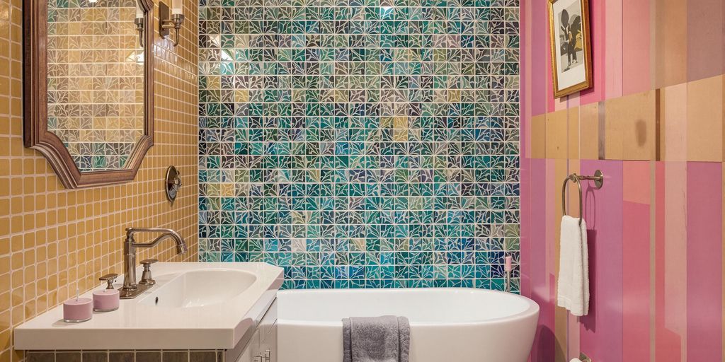 Colorful bathroom accent wall with unique textures and patterns.