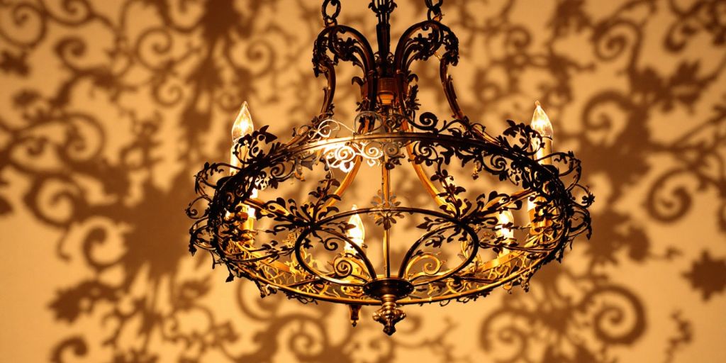 Elegant metal chandelier with warm ambient lighting.