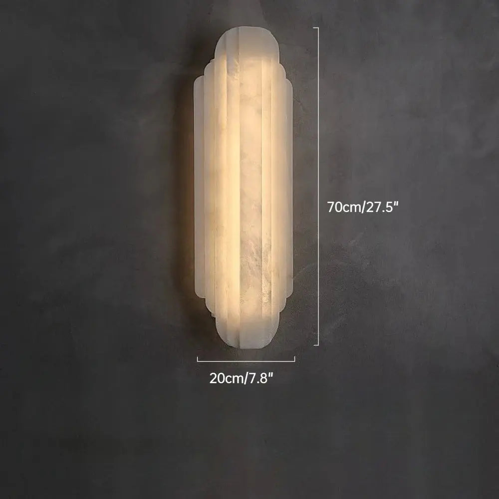 Wall-mounted light fixture on a dark gray wall with measurements indicated.