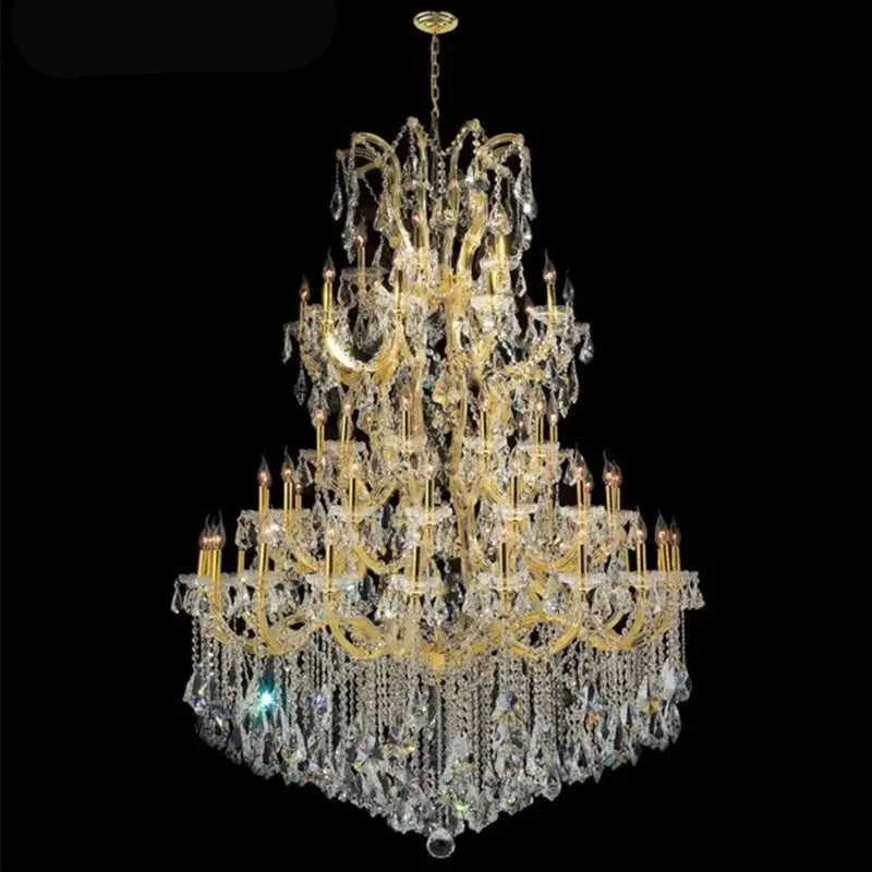 Large crystal chandelier with gold accents on a black background, 
