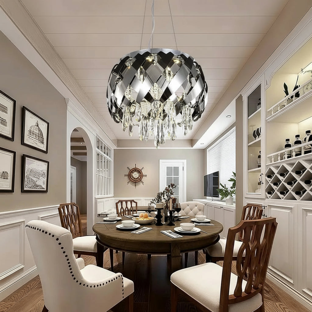 Dining room with a modern chandelier, round table, and chairs.