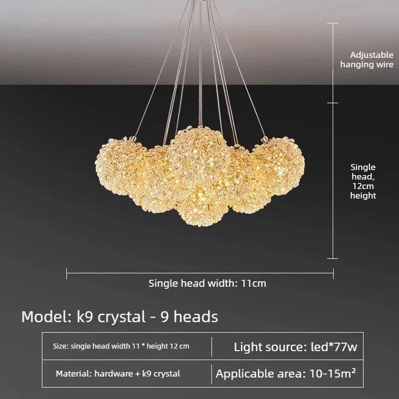 A 9-head crystal chandelier pendant light shown against a dark gradient background, with overlaid dimension labels indicating single head width of 11cm, single head height of 12cm, and adjustable hanging wire. Text at the bottom includes model k9 crystal, 9 heads, size details, light source LED*77w, material, and applicable area 10-15m2.