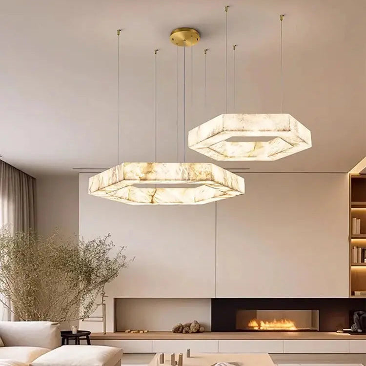 Modern living room with hexagonal pendant lights, a fireplace, and a sofa.