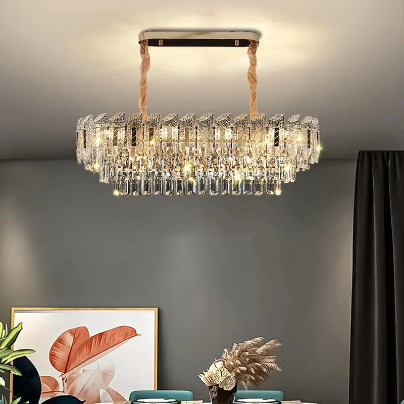 Chandelier hanging in a room with a gray wall and decorative elements.